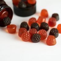 Vitamins for children, marmalade on a white background with a brown bottle.